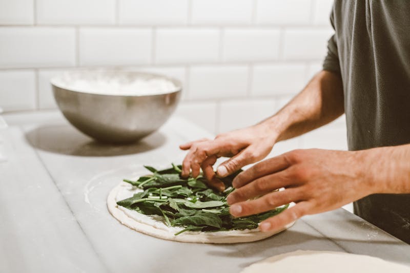 Marcos pizza dough masters hand-tossing pizza dough in the kitchen